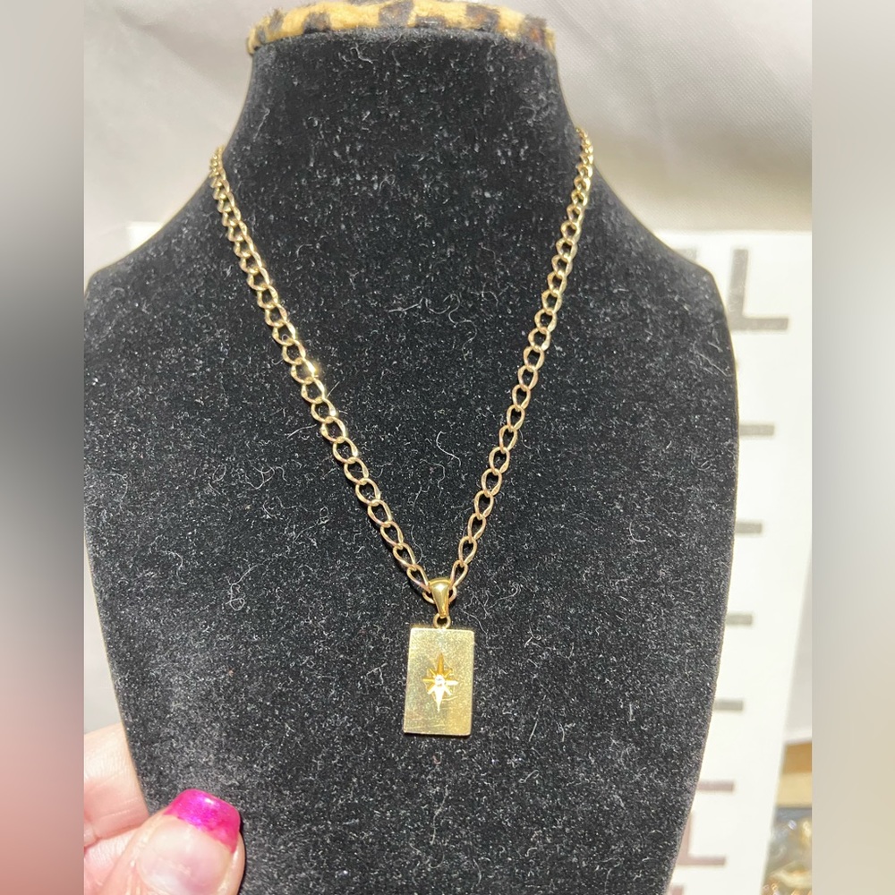 Gold Tone Pendant Necklace. Pendant is a Northern Star Witb Center rhinestone